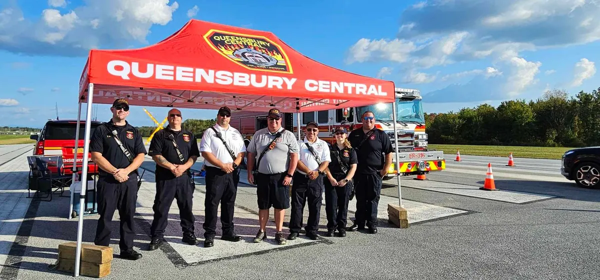 Queensbury Central firefighters under their custom printed canopy tent